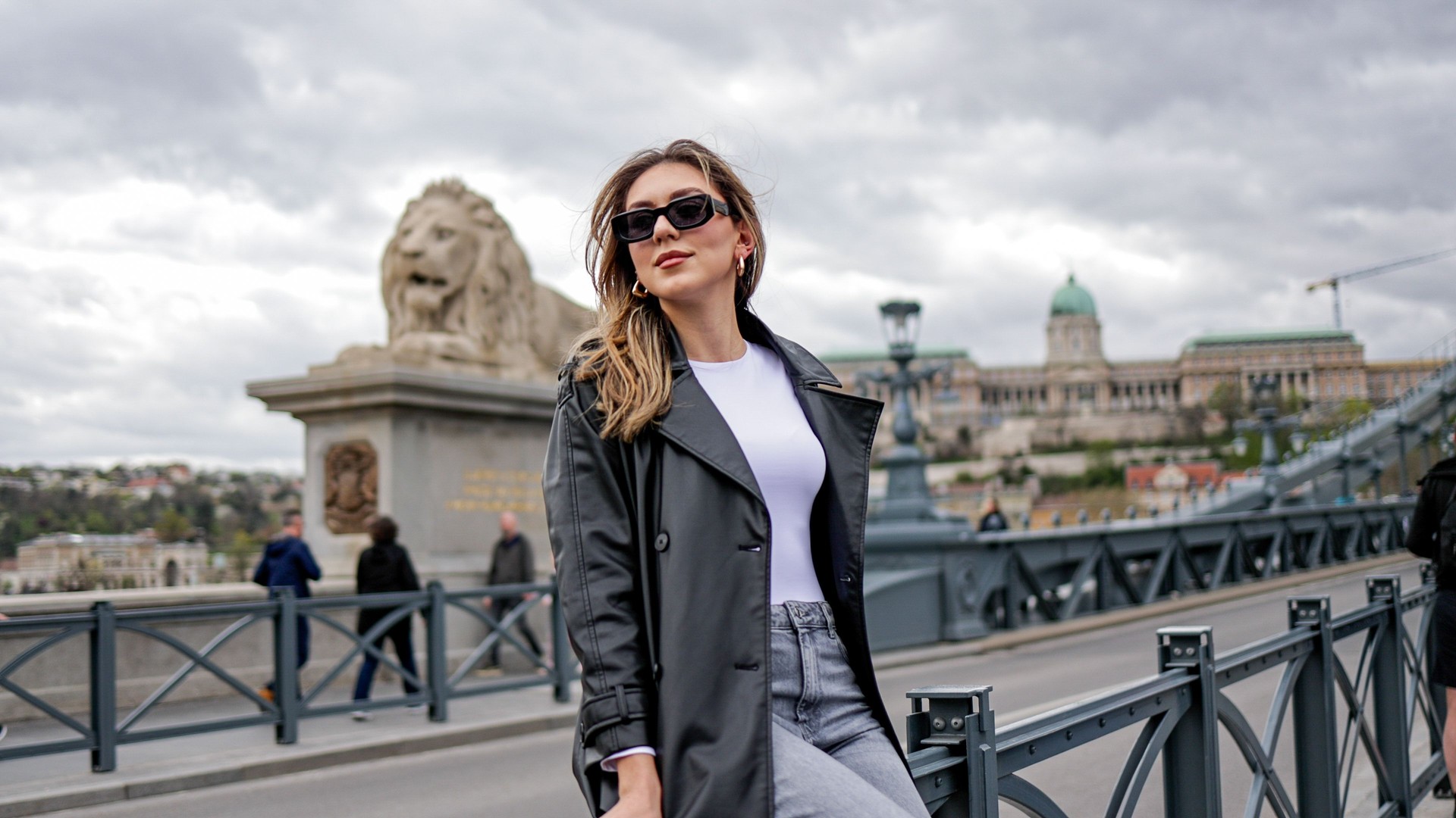 Young Woman Exploring Chain Bridge and Surroundings in Budapest, Hungary – Capturing the Charm of European Architecture and Urban Life in the Heart of the City